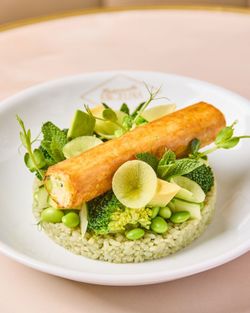 Green vegetable dish with peas, avocado, broccoli, and a crispy pastry on top at Mademoiselle Angelina tea room.