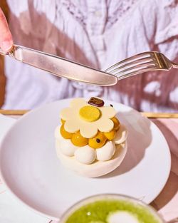 A delicate Mont-Blanc pastry topped with a white chocolate flower, placed on a white plate in the tea room.