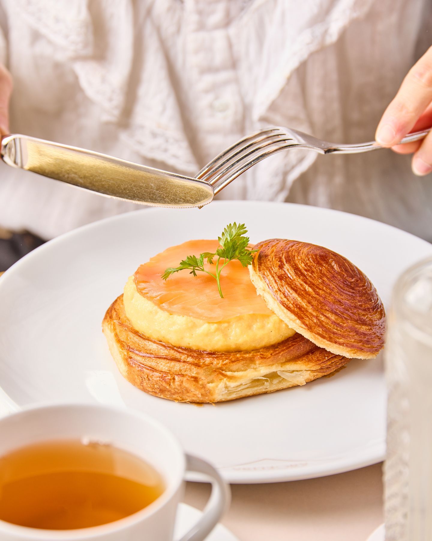 Puff pastry dessert served with tea in a classic tea room setting at Mademoiselle Angelina.